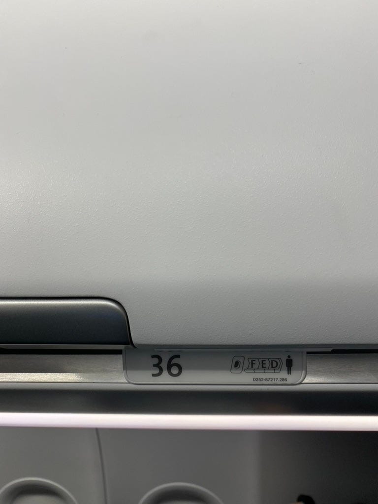 Seat placard on an aircraft showing seating arrangement.