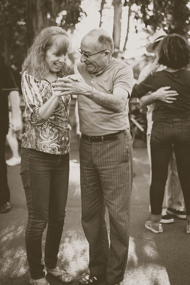 Dance class participants engaging in movement therapy